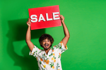 Photo portrait of attractive young man hold excited sale plate wear trendy citrus print clothes...