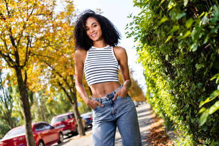 Photo of positive cute charming girl traveling in city autumn park fresh air summer weather outsideの写真素材