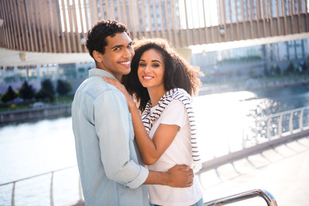 Photo of young lovely cheerful married couple smiling when hug cuddle together bonding and enjoying fresh air outdoors in natureの写真素材