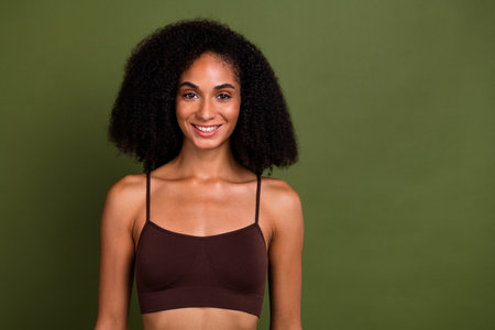 No filter studio photo of lovely adorable woman wear lingerie enjoying body positive isolated khaki color backgroundの写真素材