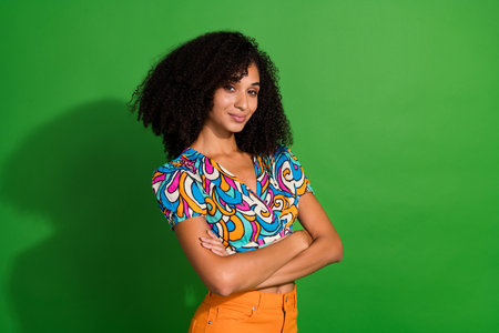 Portrait of smart lady with chevelure wearing old style vintage top folded arms poses model glad...