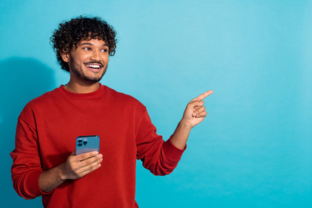 Photo of young arabian student recommend offers in online service mobile apps point finger copyspace...