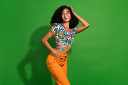 Photo of charming lady chevelure hairstyle touching after new shampoo looking empty space brand isolated on green color backgroundの写真素材