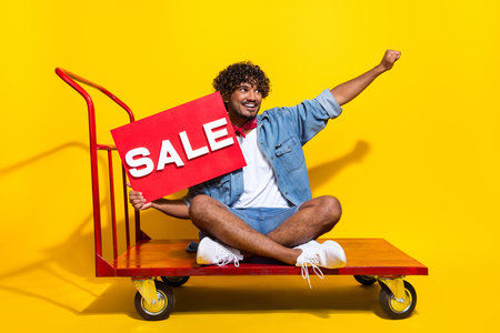 Full size photo of nice young male shipment cart hold sale plate dressed stylish denim outfit red...
