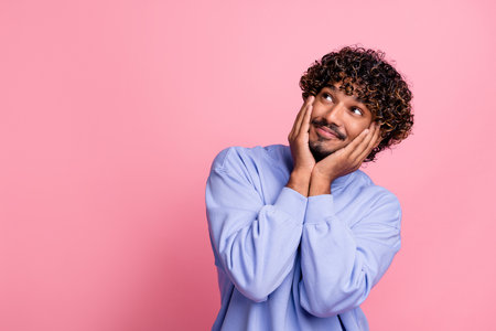 Photo of positive glad man wear blue trendy clothes arms touch face seasonal price sale empty space isolated on pink color backgroundの写真素材