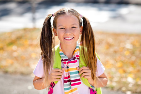 Photo of sweet funky little girl dressed tied sweater rucksack travelling enjoying sightseeing...