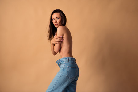 Unretouched photo of girl wear oversize denim cover breast feel