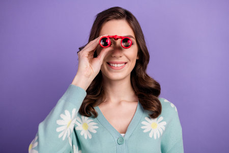 Photo of funky good mood lady dressed flower print cardigan looking you binocular isolated violet...