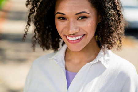 Photo of adorable good mood woman dressed white shirt enjoying good warm weather outdoors urban city parkの写真素材