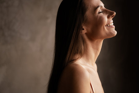 Profile side photo of cute gorgeous lady love herself care body skin perfect ideal face no filter isolated on grey concrete wall backgroundの写真素材