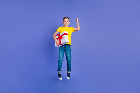 Photo of beautiful cheerful cute boy wear trendy yellow clothes celebrate birthday receiving gift...
