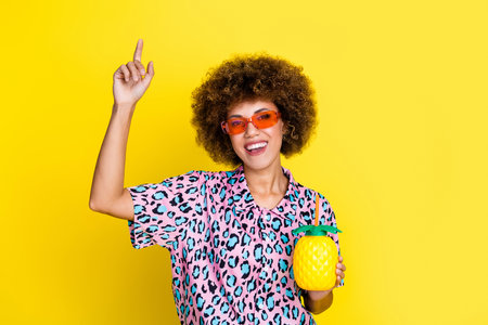 Photo of sweet funky woman wear animal print shirt dark glasses drinking fruit cocktail isolated...
