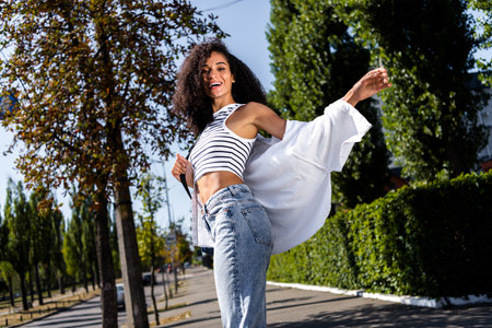 Photo of gorgeous smiling cute girl wear trendy white outfit have fun enjoy sunny season outsideの写真素材