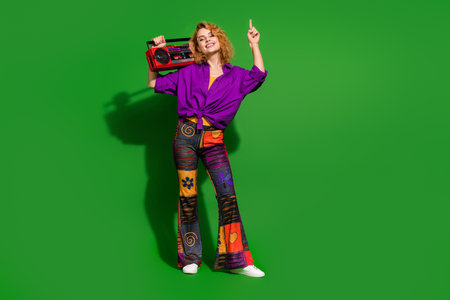 Photo portrait of pretty young girl point up empty space hold boombox wear trendy purple outfit...