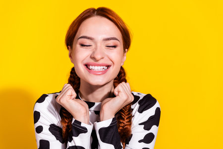 Photo of cheerful excited lady dressed cowskin top dreaming empty space isolated yellow color...