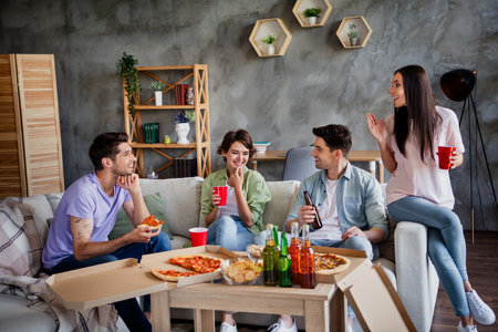 Portrait of company best friends hanging out chatting drink beer eat pizza free time chill flat indoorsの写真素材