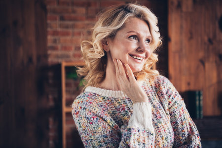 Photo portrait of lovely retired woman look empty space touch face dressed casual outfit cozy home...
