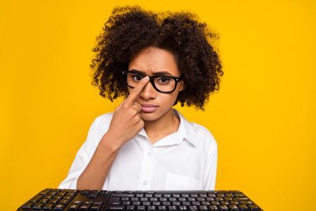 Portrait of serious person finger touch adjust eyeglasses look camera smart casual isolated on yellow color backgroundの写真素材