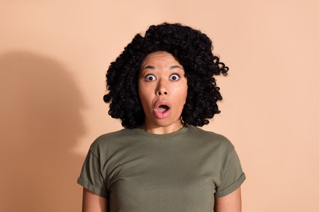 Photo portrait of pretty young woman shocked face open mouth dressed trendy khaki outfit isolated on beige color backgroundの写真素材