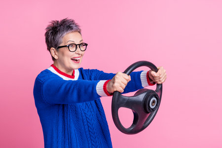 Photo of nice cheerful funny woman wear stylish clothes hold steering wheel drive fast empty space...