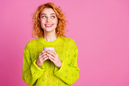 Portrait of cute pretty woman wear stylish green clothes hands hold cup tasty drink look empty space...