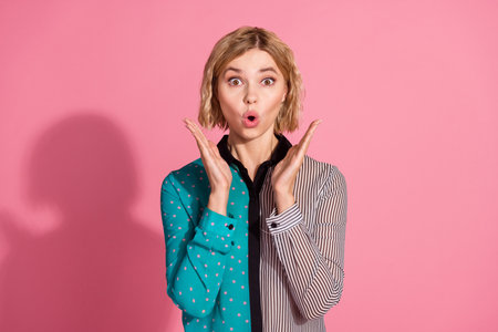 Photo portrait of pretty young girl raise hands shocked wear trendy striped cyan outfit isolated on...