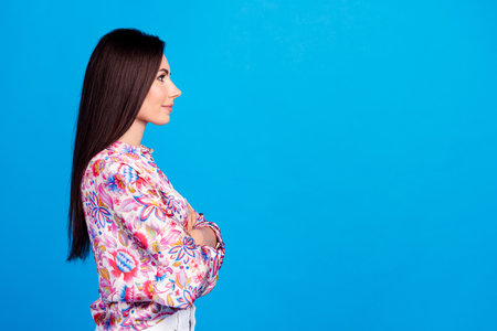 Photo of serious confident lady dressed print blouse arms folded empty space isolated blue color backgroundの写真素材