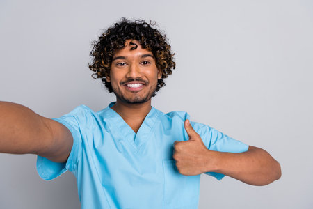 photo of doctor guy make selfie show fine thumb up symbol isolated grey color backgroundの写真素材