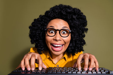 Portrait of pretty lady write keyboard wear yellow shirt isolated on khaki color backgroundの写真素材