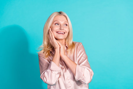 Portrait of pretty elegant lady look empty space wear shirt isolated on turquoise color backgroundの写真素材