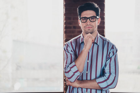 Photo of nice young corporate man contemplate wear striped shirt loft interior office indoorsの写真素材