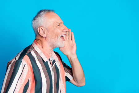 Photo of cheerful glad retired man wear striped stylish clothes share news isolated on blue color backgroundの写真素材