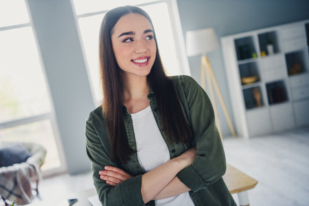 Photo of gorgeous young lady crossed arms brainstorm wear shirt spacious modern office home indoorsの写真素材