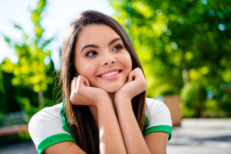 Portrait of dreamy pretty gorgeous girl hands touch face enjoying sun warm weather outside