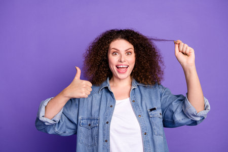 Photo of cool nice girl excited show thumb up hold hair wear denim shirt isolated on violet color...