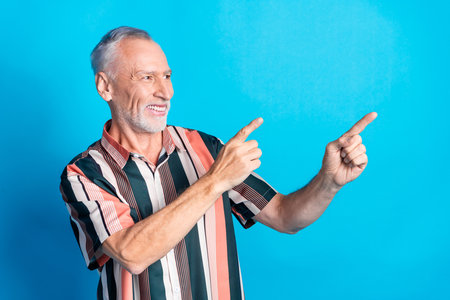 Photo of handsome satisfied retired man wear striped trendy clothes look empty space isolated on...