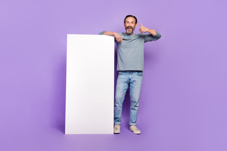 Full size photo of cheerful excited male showing thumb-up recommend product promotion isolated on violet color backgroundの写真素材