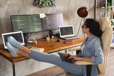 Photo of successful girl hacker wear stylish denim shirt sitting armchair using modern technology...