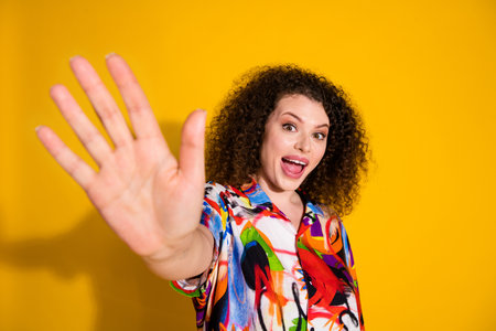 Photo portrait of pretty young girl wave hand hello wear trendy colorful print outfit isolated on...