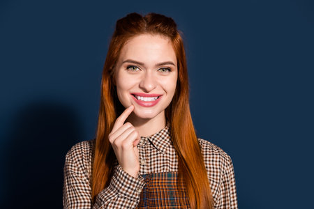 Photo of tricky funky lady dressed plaid outfit finger chin empty space isolated dark blue color...