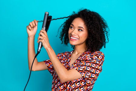 Photo of girlish lovely lady dressed print shirt straighten hair curls isolated teal color backgroundの写真素材