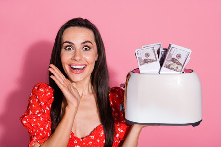 Portrait of nice young lady toaster money wear top isolated on pink color backgroundの写真素材