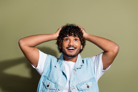 Photo portrait of nice young male amazed touch head look empty space dressed stylish denim garment...