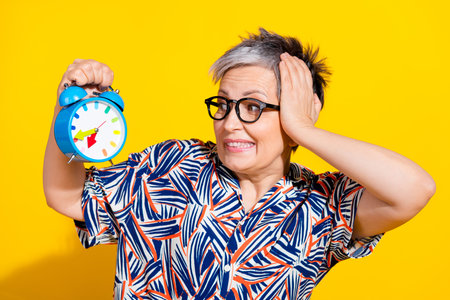 Photo portrait of nice pensioner female look worried alarm clock wear trendy colorful outfit...