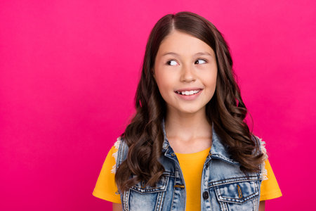 Photo of good mood girl look empty space toothy smiling isolated vivid color backgroundの写真素材