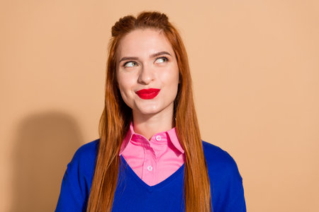 Photo of dreamy sweet lady wear sweater looking empty space isolated beige color backgroundの写真素材