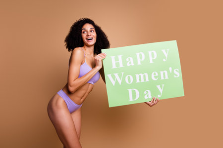 No filter portrait of stunning model girl happy women day placard look empty space isolated on beige color backgroundの写真素材