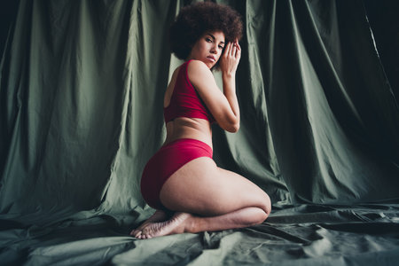 Unretouched photo of girl sit knees posing feel body comfortable isolated khaki linen backgroundの写真素材
