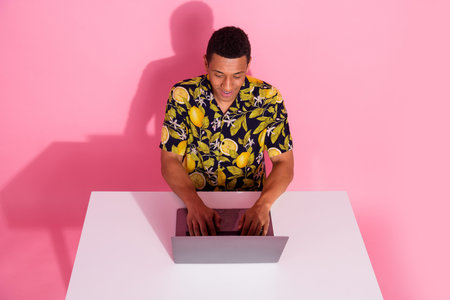 Photo of guy sit table desk using netbook writing message isolated pastel color background