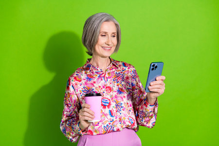 Photo of charming attractive lady wear pink blouse enjoy coffee texting modern gadget empty space...